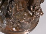 a bronze statue of a man and a dog on a pedestal