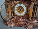 a marble clock with a magnifying glass on top of it