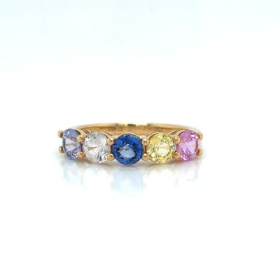 a close up of a gold ring with multi colored stones