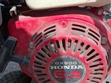 a close up of a red and white engine on a cart