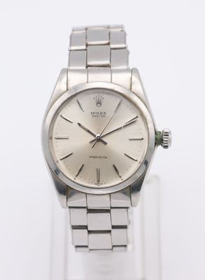 an image of a silver wrist watch with a silver dial