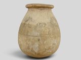 an old vase that is sitting on a white surface
