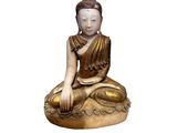 statue of a seated buddha sitting on a rock on a white background