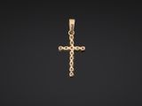 a gold cross pendant on a black background