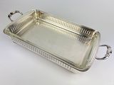 a silver tray with handles and handles on a white surface