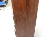a tall wooden cabinet in the middle of a room