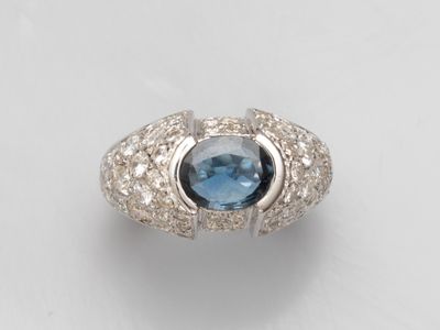 a ring with a blue topaz stone surrounded by white diamonds