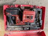 a red tool box with tools in it on the floor