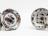 three plates with floral designs on them on a white surface