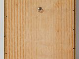 an empty wooden box on a white surface with a ring on it