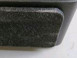 a black speaker sitting on top of a wooden table