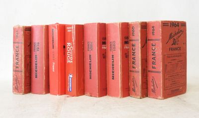 several books are lined up in a row on a white surface