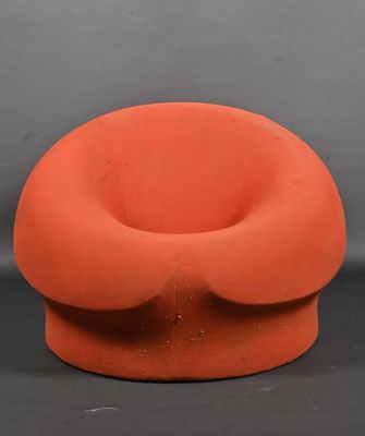 an orange chair sitting on top of a black surface