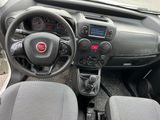 the interior of a small car with a steering wheel and dashboard controls