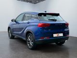 the rear end of a blue car parked in a garage
