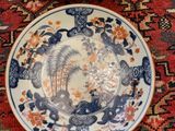 two plates that are sitting on a red rug