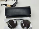 versa versa sunglasses and case on a table with a pair of sunglasses