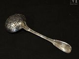 a spoon and spoon rest on a black surface