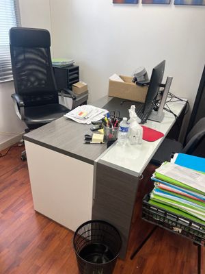 a desk with a chair and a computer on it