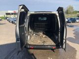 a van that is parked in a parking lot with its doors open