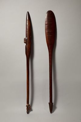 pair of wooden paddles on a white background with a gray background