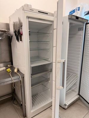 deux réfrigérateurs ouverts placés l'un à côté de l'autre dans une cuisine