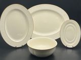 a group of white plates and bowls sitting on top of a table