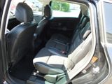 the back seat of a car with a suitcase in the back of it