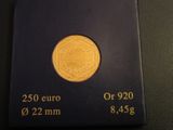 a close up of a gold coin on a black surface