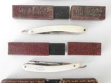 several different types of knives are lined up on a white surface