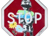un panneau « Stop » sur lequel figure l'image d'une personne tenant une fleur