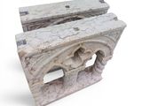 two pieces of stone sitting next to each other on a white surface