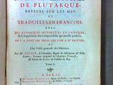an old book with french writing on it sitting on top of a table