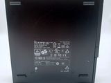 the back of a black laptop with a black battery on it