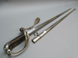 two swords that are laying next to each other