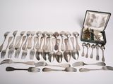 many forks and spoons laid out on the table