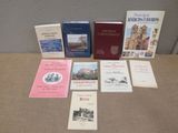 several books are sitting on a table in front of a wall