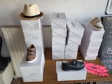 boxes of shoes and a hat on a table with a hat on top