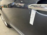 a close up of a car door handle with a sticker on it
