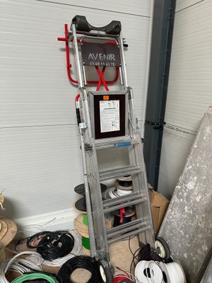 a ladder that is next to a pile of wires
