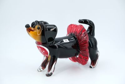 a black and red dog figurine with a tutu skirt