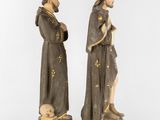 two figurines of a man and a woman standing next to each other