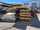 a large pile of metal in a yard with a building in the background
