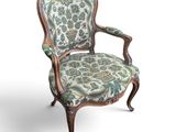 a chair with a floral upholstered seat and a wooden frame