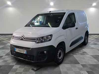 la camionnette blanche est garée dans une grande pièce au sol en damier