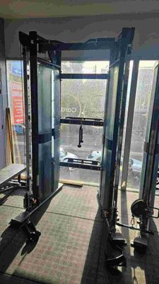 a gym room with machines and benches in it