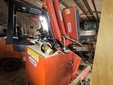 a forklift that is sitting in a warehouse