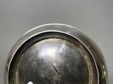 a close up of a silver plate with a tag on it
