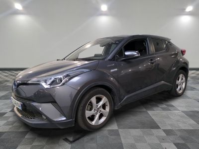 La Toyota C-HR grise est garée dans une pièce dont le sol est à carreaux.