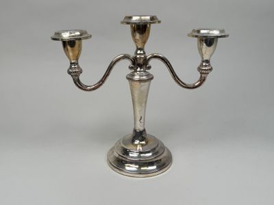 an image of a silver plated three - light candle holder on a white background